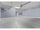 Spacious garage with storage racks and painted concrete floor at 9727 E Torino Ave, Mesa, AZ 85212