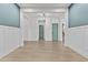 Hallway with blue accent wall, and views to staircase and doors at 9727 E Torino Ave, Mesa, AZ 85212