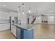 Open-concept kitchen includes a blue island and stainless steel appliances at 9727 E Torino Ave, Mesa, AZ 85212