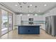 Modern kitchen with a navy island, stainless steel appliances, and stylish pendant lighting at 9727 E Torino Ave, Mesa, AZ 85212
