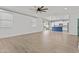 Bright, open-concept living room featuring modern light fixtures and wood flooring at 9727 E Torino Ave, Mesa, AZ 85212