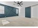 Large main bedroom featuring an accent wall, a ceiling fan, and a sliding barn door at 9727 E Torino Ave, Mesa, AZ 85212