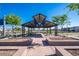 Park pavilion with tables and landscaping in a Gathering friendly neighborhood at 9727 E Torino Ave, Mesa, AZ 85212