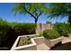 Well-maintained backyard featuring a raised garden bed and lush landscaping providing a private outdoor space at 9842 E Celtic Dr, Scottsdale, AZ 85260
