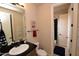 Bathroom with a black counter top and wood cabinets, with an open door to the shower and toilet at 9842 E Celtic Dr, Scottsdale, AZ 85260