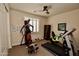 Exercise room with gym equipment, a ceiling fan, and natural light from a window at 9842 E Celtic Dr, Scottsdale, AZ 85260