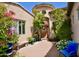 Charming front entry with a courtyard, lush plants, and a custom wood door at 9842 E Celtic Dr, Scottsdale, AZ 85260