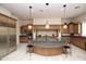 Gourmet kitchen features granite countertops, custom cabinets, and stainless steel appliances at 9842 E Celtic Dr, Scottsdale, AZ 85260