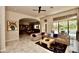 Bright living room with tile floors and access to backyard entertaining area at 9842 E Celtic Dr, Scottsdale, AZ 85260