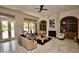 Comfortable living room featuring neutral decor, built-in shelving, fireplace, and tile flooring at 9842 E Celtic Dr, Scottsdale, AZ 85260