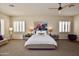 Serene main bedroom with neutral decor, plush carpet, shuttered windows, and modern bedside tables at 9842 E Celtic Dr, Scottsdale, AZ 85260
