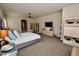 Large main bedroom featuring a ceiling fan, neutral decor, and views into the hallway and bathroom at 9842 E Celtic Dr, Scottsdale, AZ 85260