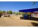 Neighborhood playground with a blue canopy and various play structures for recreation at 9842 E Celtic Dr, Scottsdale, AZ 85260