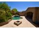 An inviting backyard featuring a refreshing pool, spa, fire pit, and covered patio for outdoor enjoyment at 9842 E Celtic Dr, Scottsdale, AZ 85260