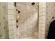 Bright and clean shower with beige tile and dual shower heads, featuring built-in seating and stylish fixtures at 9842 E Celtic Dr, Scottsdale, AZ 85260