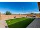 Backyard featuring artificial grass, brick walls and string lights at , Avondale, AZ 85323