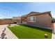 Spacious backyard with artificial grass, brick pavers, a built-in BBQ, and ample room for outdoor activities at , Avondale, AZ 85323