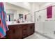 Bright bathroom featuring a double sink vanity, large mirror and separate glass-enclosed shower at , Avondale, AZ 85323