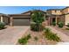 Charming single-Gathering home with a well-manicured front yard, paver driveway, and a two-car garage at , Avondale, AZ 85323