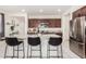 Bright kitchen with stainless steel refrigerator, granite counters, and island with seating at , Avondale, AZ 85323