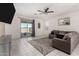 Bright living room featuring tile floors, neutral walls, a ceiling fan, and sliding glass doors to the patio at , Avondale, AZ 85323