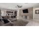 Open concept living room featuring tile flooring, wood accent wall, modern ceiling fan, and an adjacent kitchen at , Avondale, AZ 85323