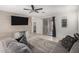 Comfortable living room with tile flooring, ceiling fan, a gray sofa, and sliding door leading to backyard at , Avondale, AZ 85323