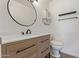 Charming powder room featuring a modern vanity, decorative mirror, and stylish fixtures at 10201 N 97Th Ave # B, Peoria, AZ 85345