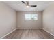 Bright bedroom with wood-look flooring, window for natural light, and neutral tones for a peaceful ambiance at 10201 N 97Th Ave # B, Peoria, AZ 85345