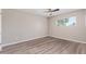 Bright bedroom with wood-look flooring, a window for natural light, and neutral walls creating a calming retreat at 10201 N 97Th Ave # B, Peoria, AZ 85345