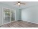 Bright bedroom featuring a ceiling fan and sliding glass doors leading to the outside at 10201 N 97Th Ave # B, Peoria, AZ 85345