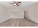Bright, open bedroom featuring wood-look flooring, ceiling fan, and neutral paint, creating a serene atmosphere at 10201 N 97Th Ave # B, Peoria, AZ 85345