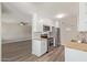 Open kitchen with white cabinets, stainless steel appliances, and view into another room, enhancing the living space at 10201 N 97Th Ave # B, Peoria, AZ 85345