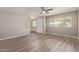 Bright living room showcasing stylish flooring, ceiling fan, and natural light from the windows at 10201 N 97Th Ave # B, Peoria, AZ 85345