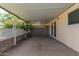 Relaxing covered patio with sliding glass door access to the house, with decorative brickwork at 10201 N 97Th Ave # B, Peoria, AZ 85345