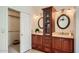 Bathroom featuring double vanity sinks, a mirror cabinet, and a doorway to the walk-in closet at 10522 E Bella Vista Dr, Scottsdale, AZ 85258