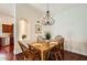 Cozy dining room with hardwood floors, chandelier lighting, and views of the kitchen at 10522 E Bella Vista Dr, Scottsdale, AZ 85258