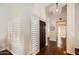 Bright foyer with wood floors, shuttered windows, and a unique pendant light fixture at 10522 E Bella Vista Dr, Scottsdale, AZ 85258