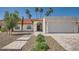Charming single-story home featuring a red tile roof, landscaped yard, and a two-car garage at 10522 E Bella Vista Dr, Scottsdale, AZ 85258