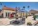 Outdoor patio with seating area, red fridge and tiled floors for relaxing and entertaining guests at 10522 E Bella Vista Dr, Scottsdale, AZ 85258