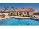 Beautiful backyard pool with a charming white house and red tile roof, ideal for outdoor living at 10522 E Bella Vista Dr, Scottsdale, AZ 85258