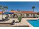Backyard with pool, patio, red fridge, and outdoor grill; great for entertaining and enjoying sunny days at 10522 E Bella Vista Dr, Scottsdale, AZ 85258