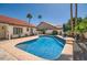 Inviting backyard pool with a charming tile surround, complemented by lush landscaping and mature palms at 10522 E Bella Vista Dr, Scottsdale, AZ 85258