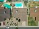 Aerial view of several houses, focusing on a house with a pool and desert landscaping at 10858 E Sahuaro Dr, Scottsdale, AZ 85259