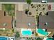 An aerial view of several houses and their backyards, highlighting the swimming pools at 10858 E Sahuaro Dr, Scottsdale, AZ 85259
