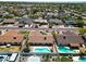 An aerial view of several houses, with a focus on a pool and nearby landscaping at 10858 E Sahuaro Dr, Scottsdale, AZ 85259