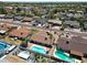 An aerial view of several houses, with a focus on a pool and nearby landscaping at 10858 E Sahuaro Dr, Scottsdale, AZ 85259