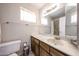 Bathroom featuring large mirror, vanity, toilet, and shower/tub combo behind a shower curtain at 10858 E Sahuaro Dr, Scottsdale, AZ 85259