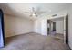 Carpeted bedroom with ceiling fan and multiple doors at 10858 E Sahuaro Dr, Scottsdale, AZ 85259