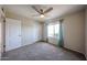 Spacious carpeted bedroom features a window with curtains, and closet with folding door at 10858 E Sahuaro Dr, Scottsdale, AZ 85259